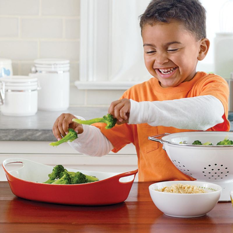 Boy cooking brocolis