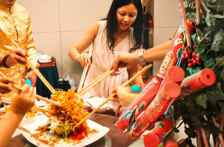 Nuren Group CEO Petrina Goh tossing Yee Sang at the start of the Annual Dinner.