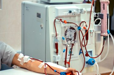 A patient having his blood cleaned via the dialysis machine.