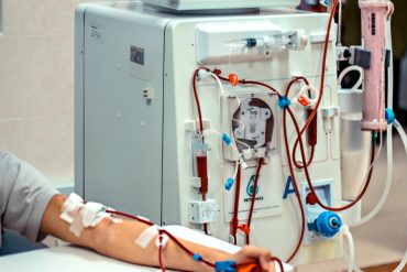 A patient having his blood cleaned via the dialysis machine.