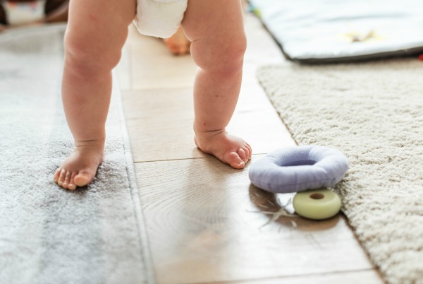 Mobile baby standing on carpet. Mummy Hacks to Make Diaper Changing