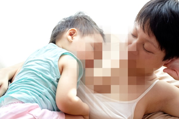 Asian toddler breastfeeding off mother. When Mum is Used as a Pacifier, Stop Comfort Nursing