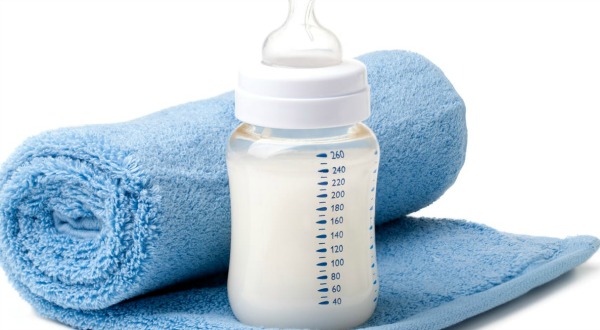 Baby bottle and Blue Towel. Crucial to Know: How to Burp a Baby