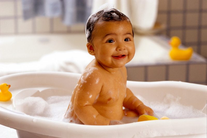Baby bathtime with rubber ducks