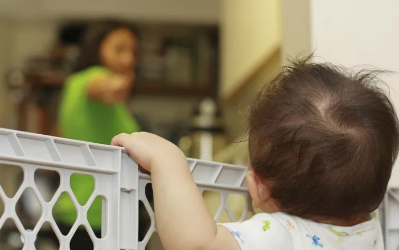 One of the best ways to keep a child out of harm’s way ─ whether it’s on the stairs, the bathroom or the kitchen ─ is to install a child or baby gate. (Image Credit: VeryWellFamily/Allen Donikowski/Moment/Getty Images)