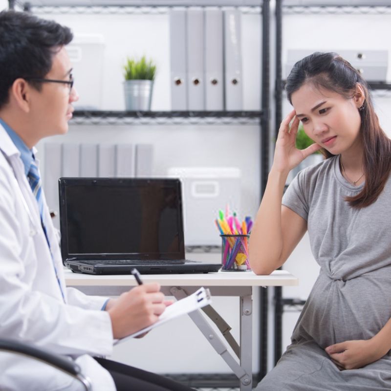 10 week pregnant mom talking to doctor
