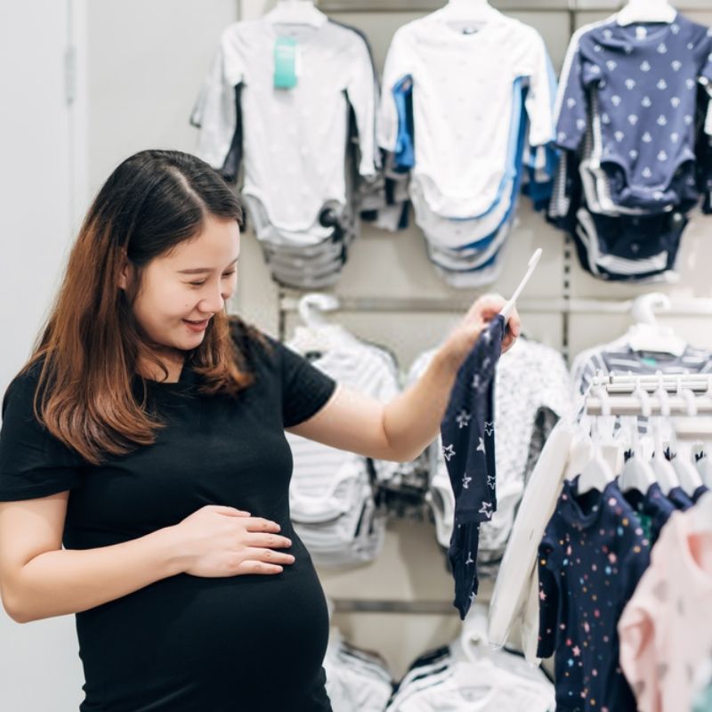 mother shopping baby clothes when 18 weeks pregnant