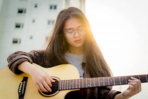 Girl Playing Guitar as one of her Hobbies