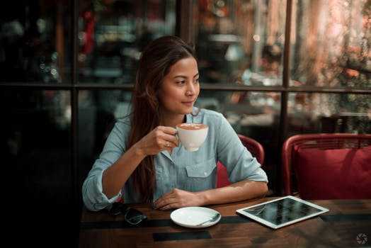 Woman Drinking Coffee With IPad