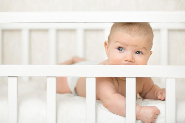 baby in baby cot