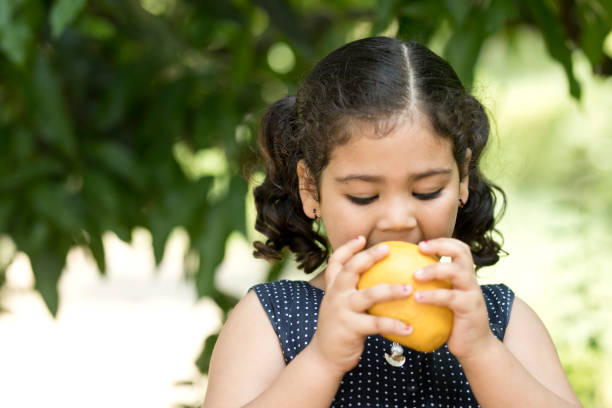 girl eating mangoes