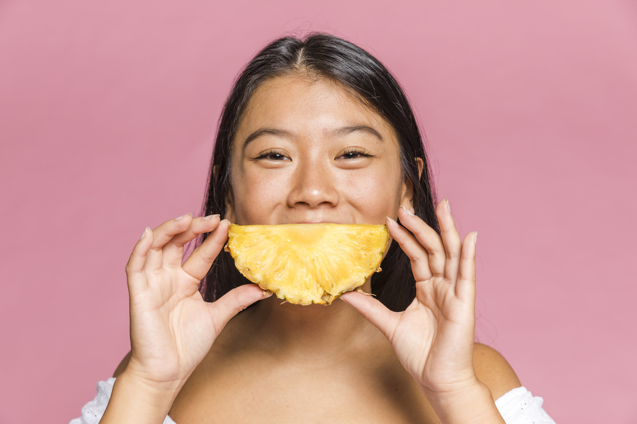 girl eating pineapple