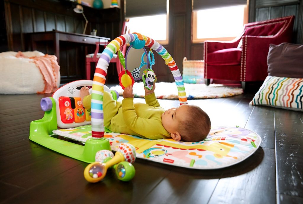baby on Fisher-Price® Deluxe Kick & Play Piano Gym (FGG45) for tummy time