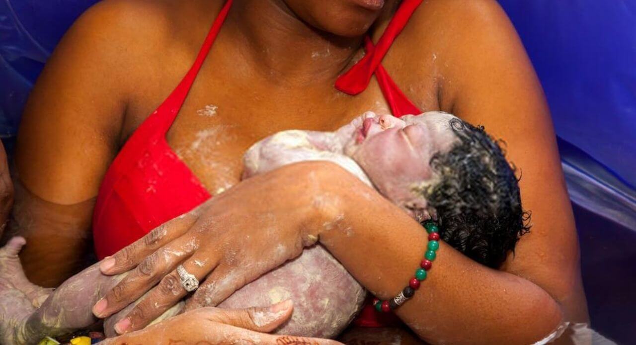 woman hugging her newborn after water labor