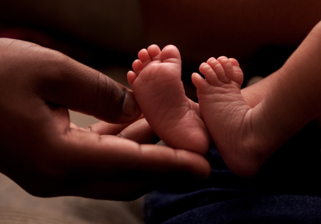 Mothers Hands Holding Baby's Feet