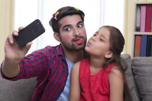 girl play makeup together with dad
