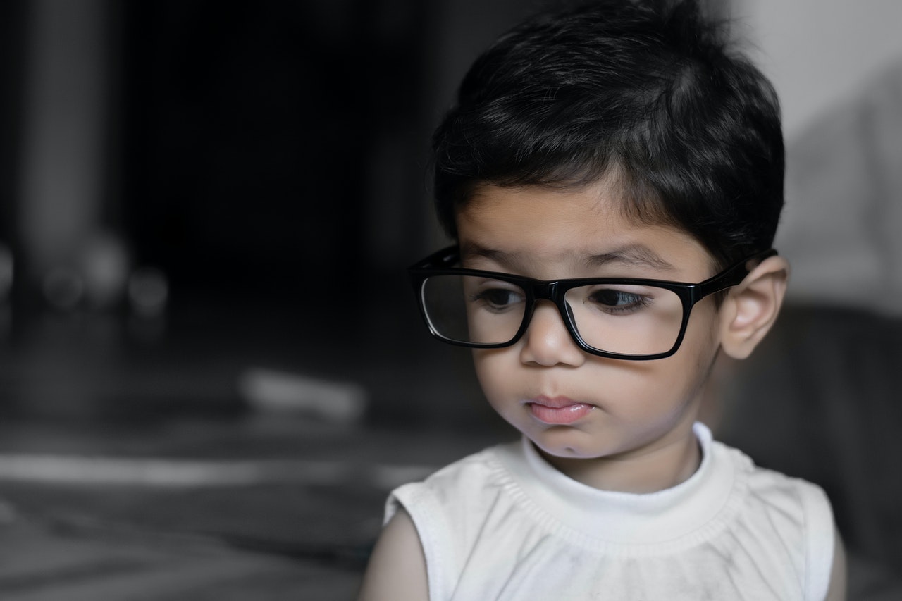 boy wearing spectacle because of frequent use of smart devices