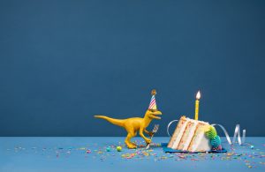 dinosaur eating birthday cake