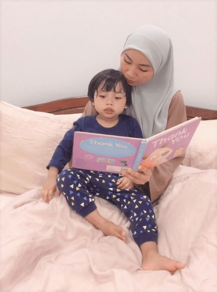Puan Fahada reading bedtime story to Yusuf. 
