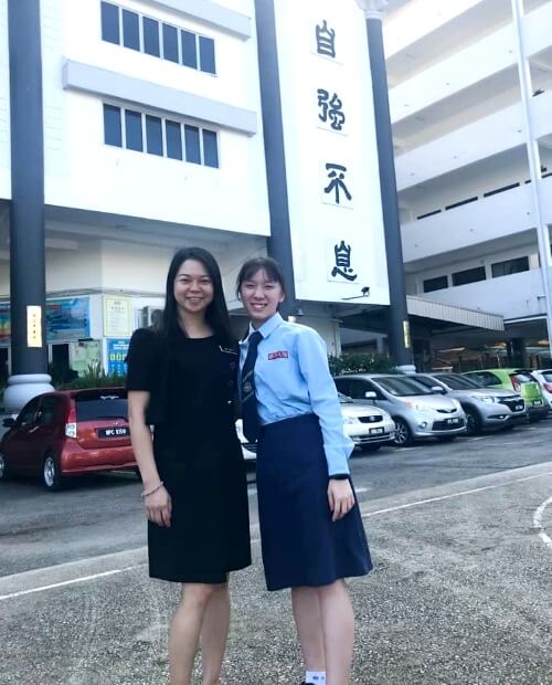 Li Ping with one of her students in front of her school.