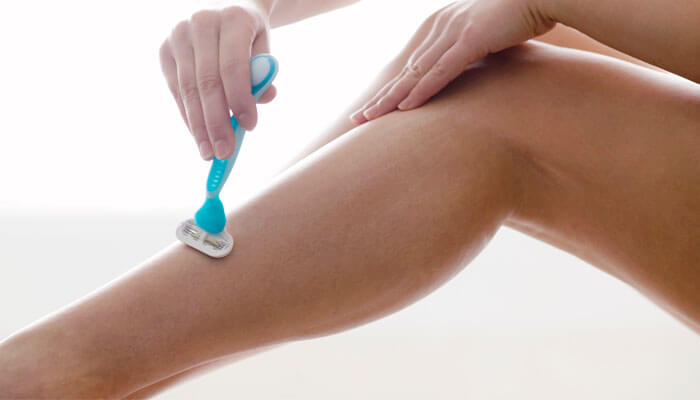 Woman Shaving Leg