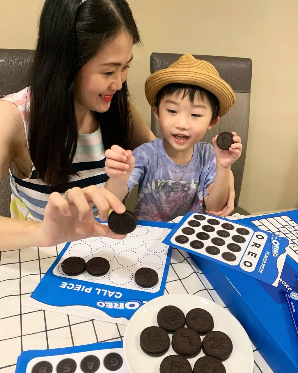 boy and his mum eating and playing with OREO