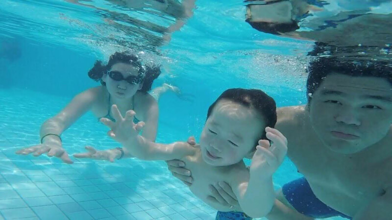 Swimming with mummy and daddy and just having fun.