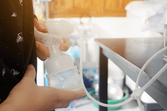 A mother is using a breast pump.