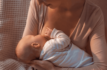 A mother is breastfeeding her baby.