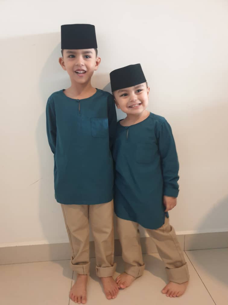 The siblings are posing in their Raya outfits.
