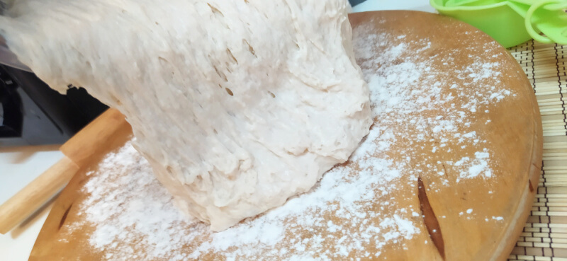 Artisan Bread Making: Pour out your sticky dough onto a lightly floured surface.