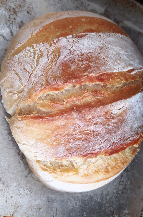 Your Artisan Bread should be bursting with goodness after 30 minutes. If it is not dark or crispy and crusty enough, pop the bread back into the oven to darken it further.