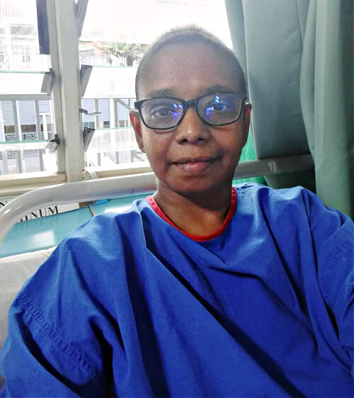 Radha back in hospital garb again in 2018, after the removal of her fallopian tubes and ovaries and the start of chemotherapy.