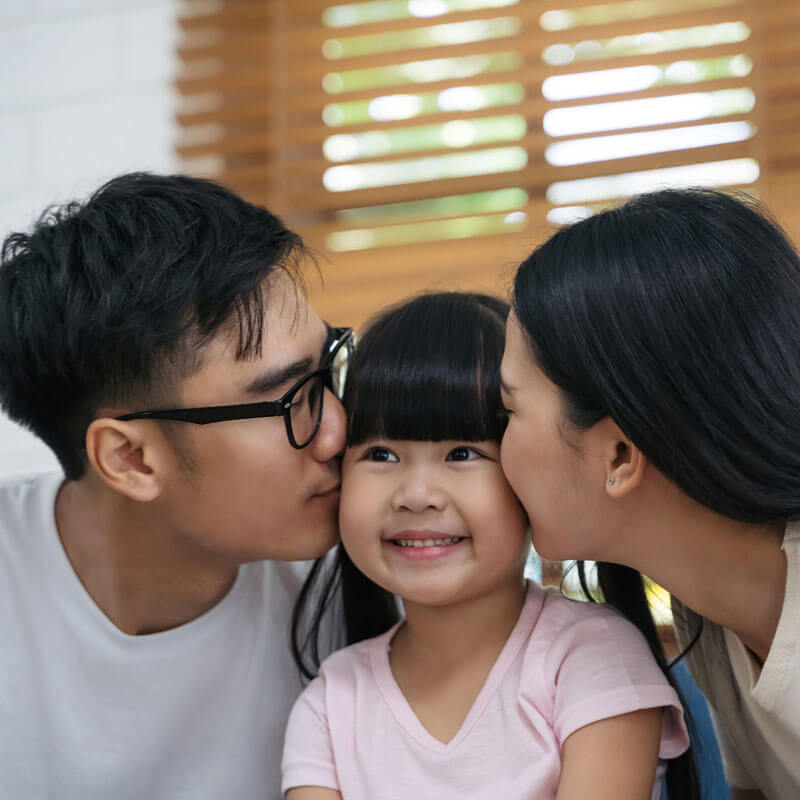 parents kissing child