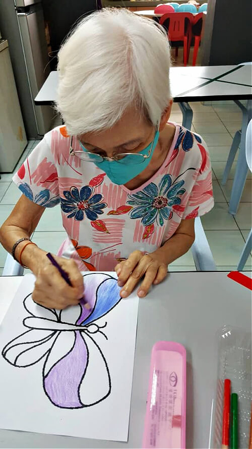 Mum carrying out activities at the centre such as colouring.