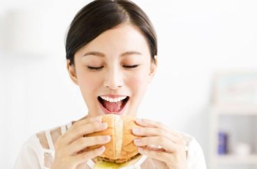 women eating burger