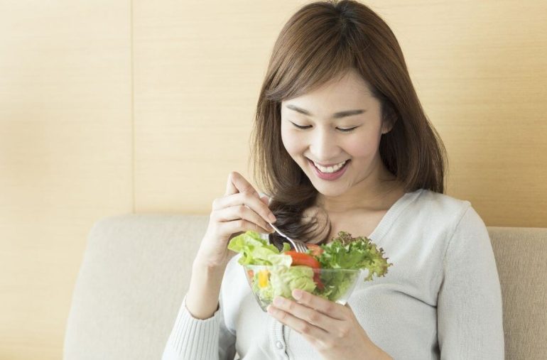 woman eating salad