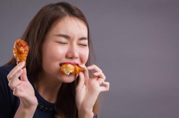 woman eating chicken