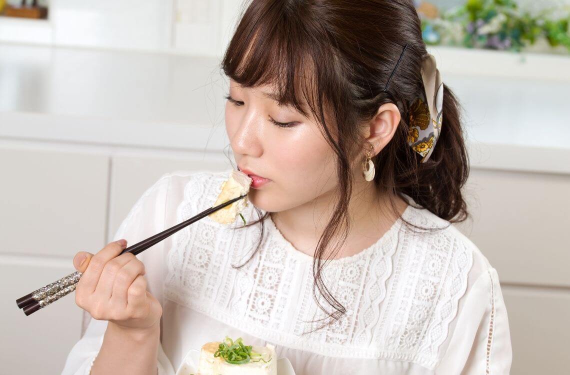 woman eating tofu