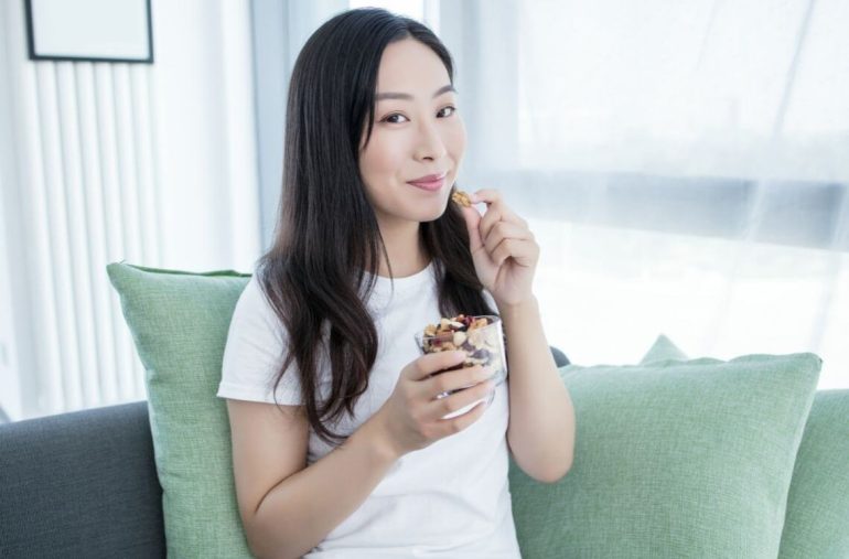 woman eating nuts