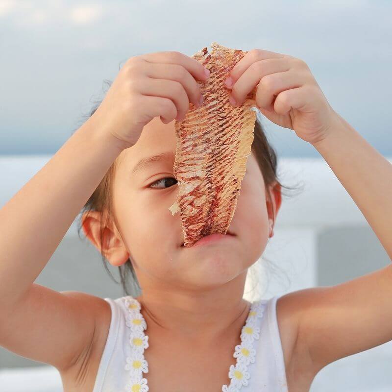child eating fish