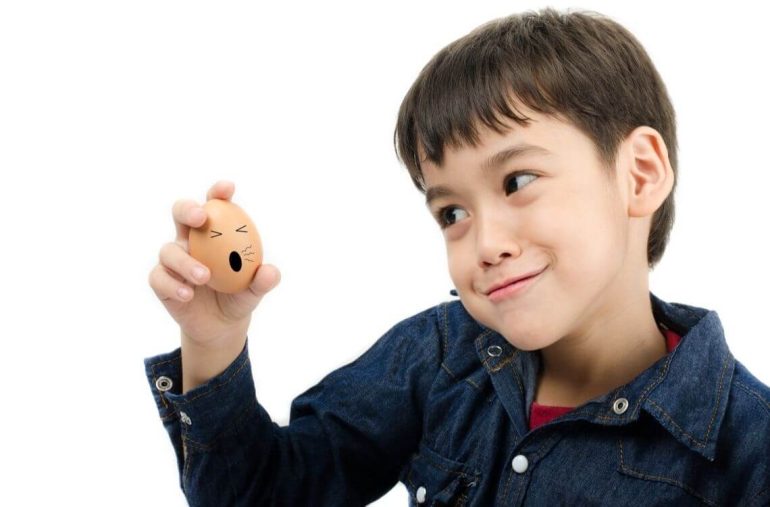 kid holding eggs