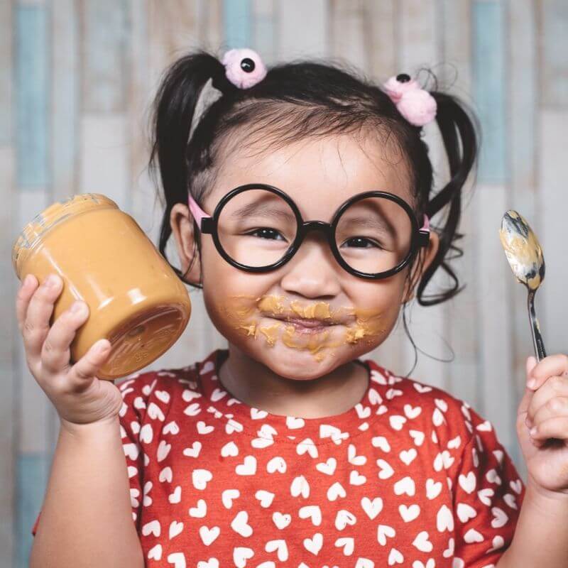 child eating peanut butter