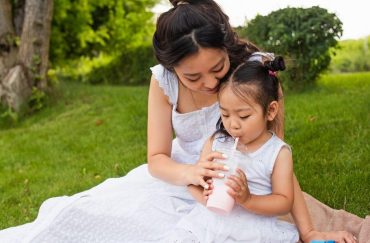 woman giving her daughter milk