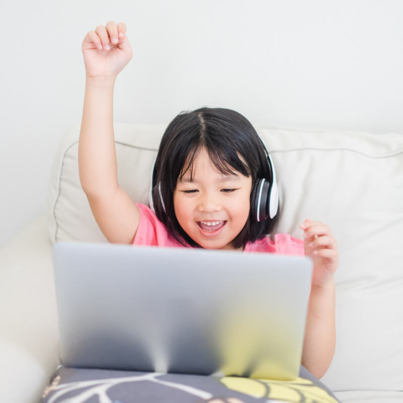 A girl is happy learning online at home