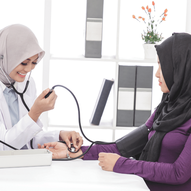 A doctor is examining a Muslim woman.