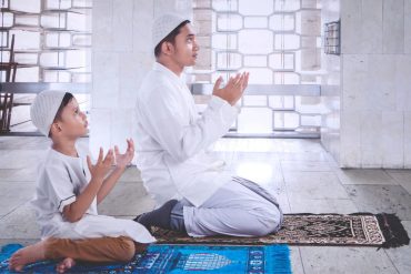 A father and son praying together