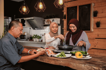 A Malay Muslim family is cooking happily in the kitchen.