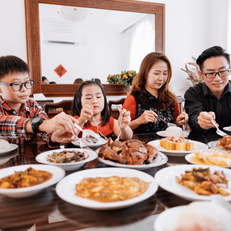 An Asian family is having a big meal.