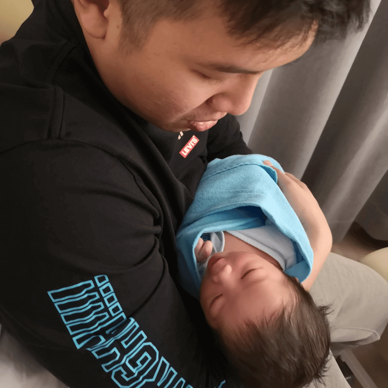 Jutzyn is holding his newborn baby boy.